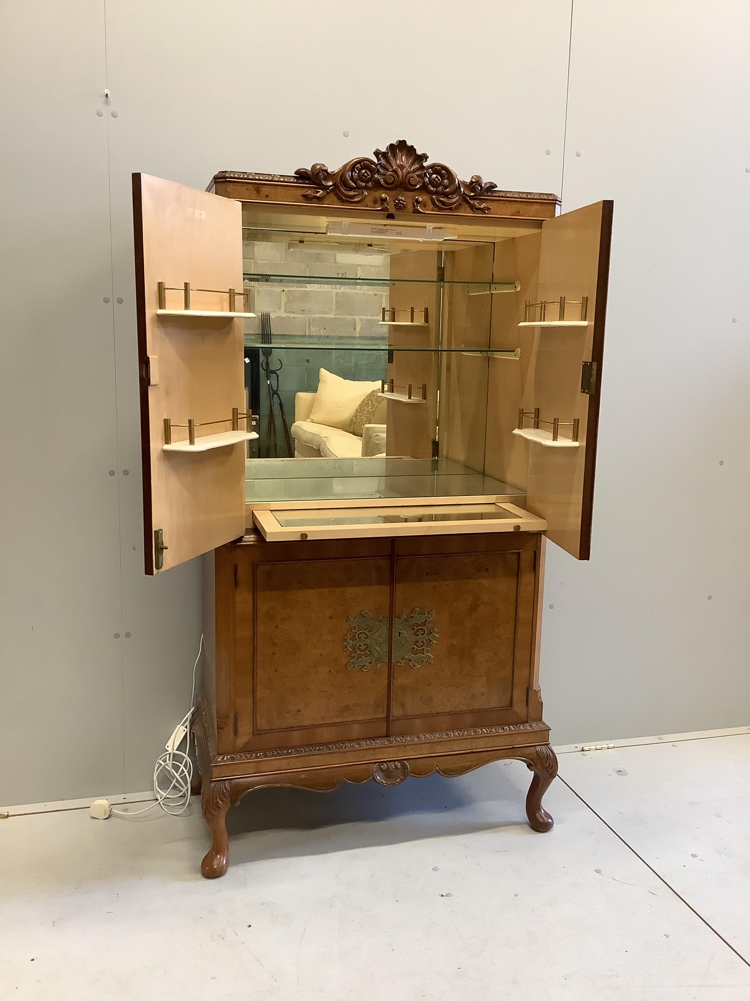 A Queen Anne Revival walnut cocktail cabinet, width 80cm, depth 40cm, height 167cm